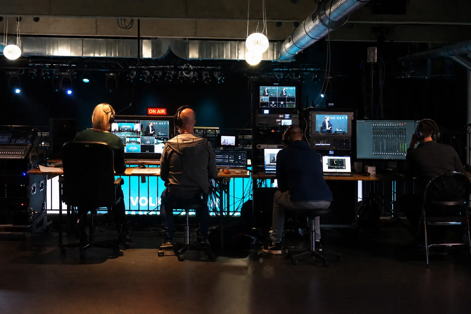 Mobile Studio4x control room with four crew members, multiview, audio mixing and streaming equipment at a corporate event
