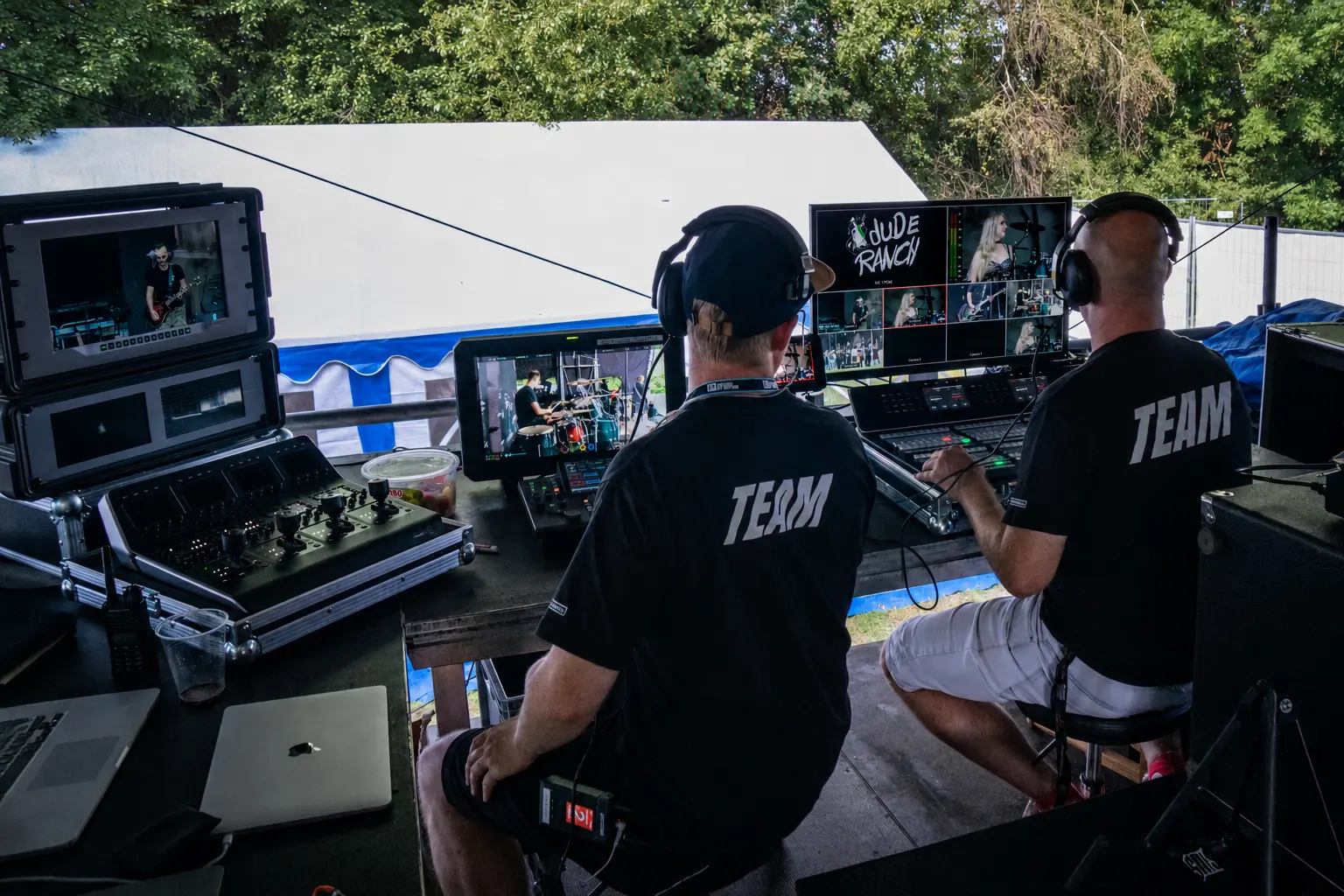 Mobile Studio4x multi-camera control room with two crew members, multiview and monitors at a concert production